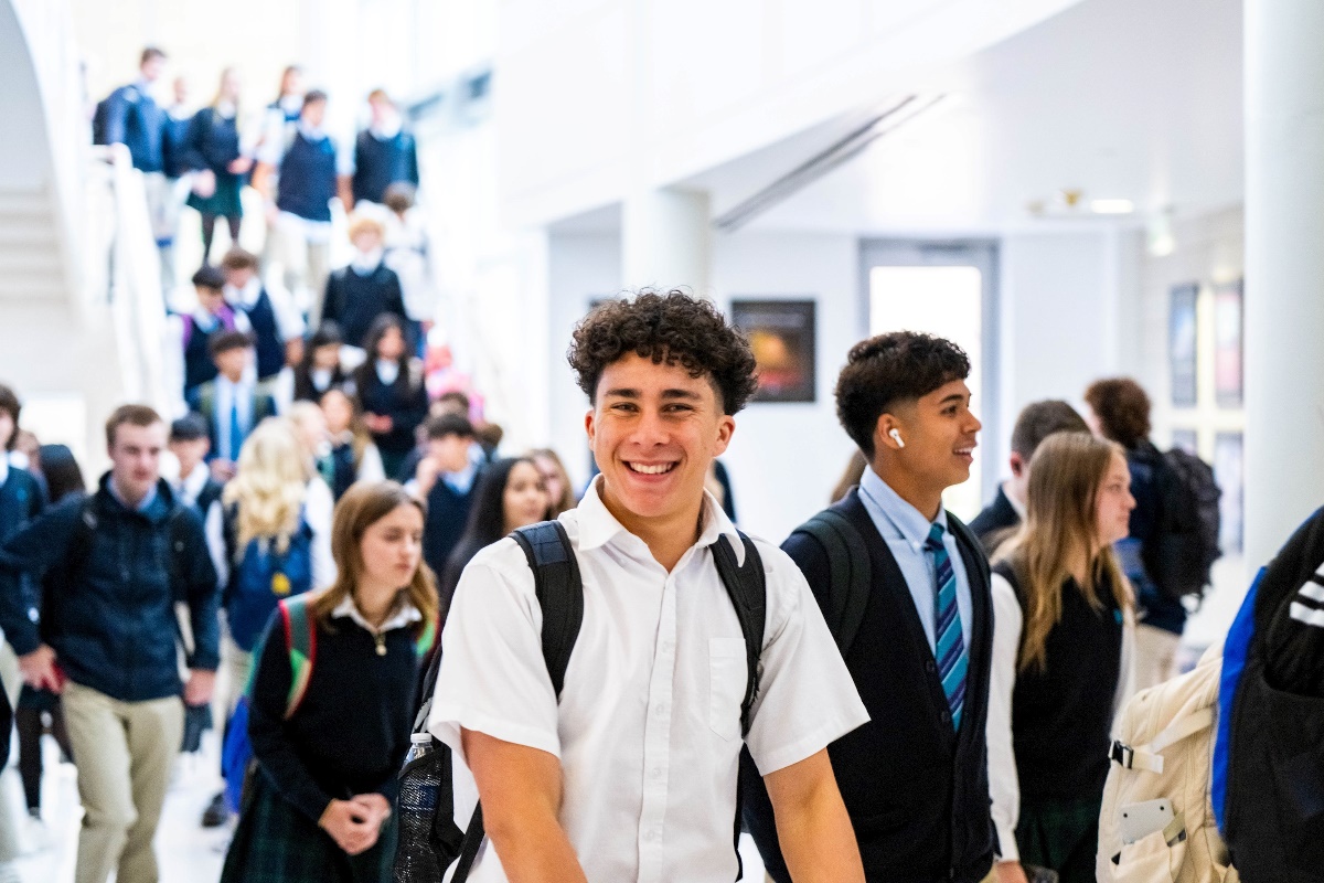 Student smiling in the Juan Diego High School corridor